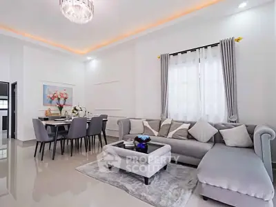 Elegant living room with modern decor and spacious dining area, featuring plush seating and ambient lighting.