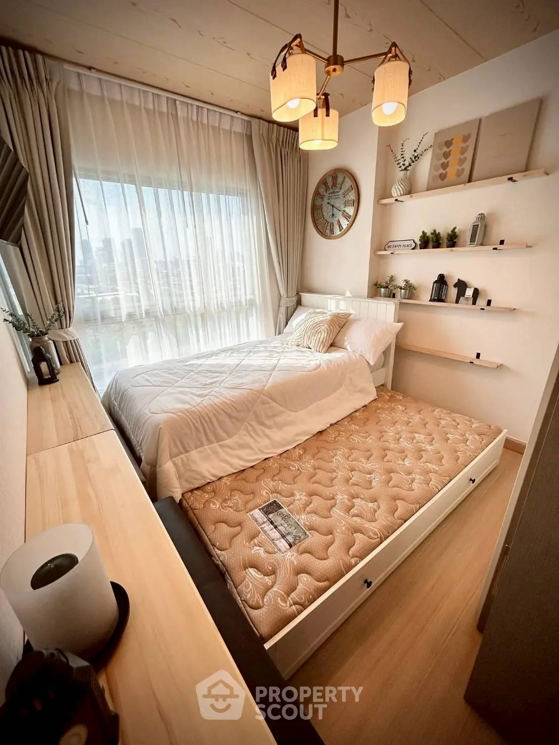 Cozy bedroom with modern decor and pull-out bed in stylish apartment