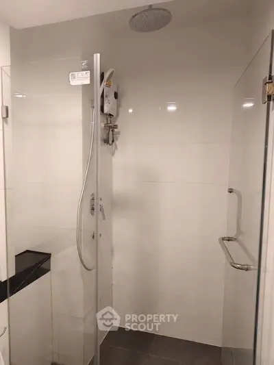 Modern bathroom with glass shower enclosure and sleek fixtures