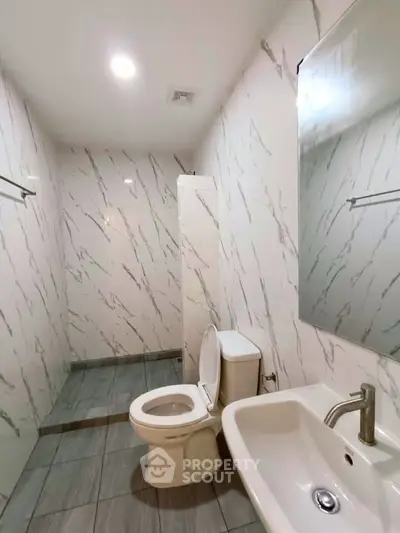 Modern bathroom with marble walls and sleek fixtures