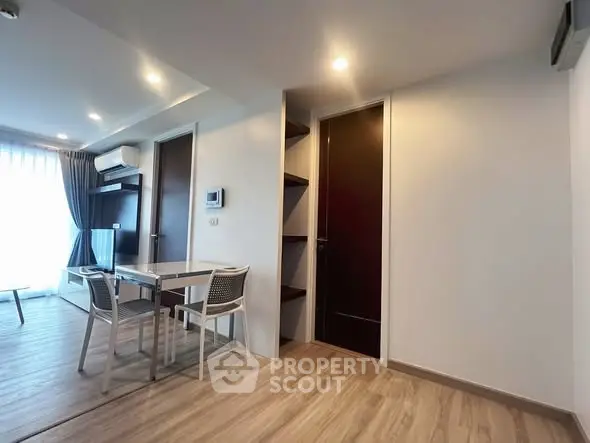 Modern apartment interior with dining area and wooden flooring