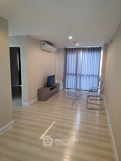 Modern living room with sleek furniture and large window