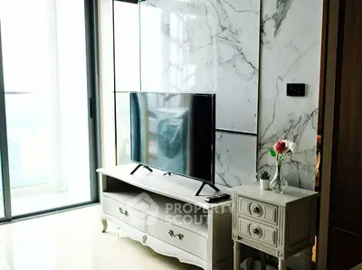 Elegant living room with modern TV setup and marble accent wall