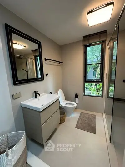 Modern bathroom with sleek fixtures and large window view