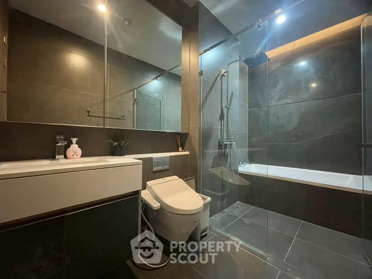 Luxurious modern bathroom with sleek design and glass shower enclosure.