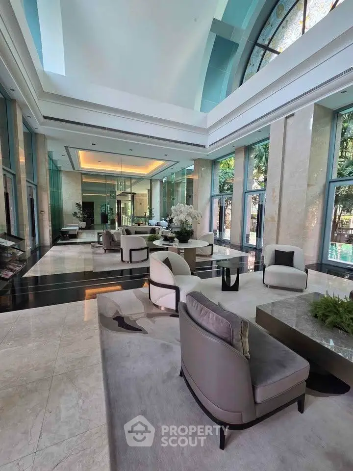 Luxurious lobby with elegant seating and high ceilings in a modern building.