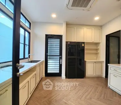 Modern kitchen with sleek cabinetry and herringbone flooring