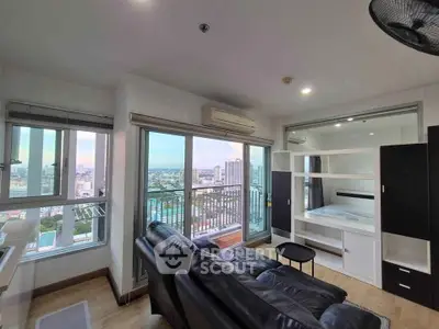 Modern living room with stunning city view and sleek black leather sofa
