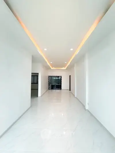 Spacious modern living room with elegant lighting and marble flooring