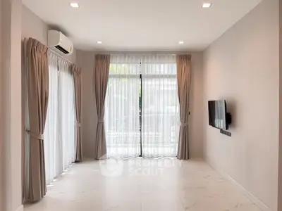 Spacious living room with large windows and modern decor