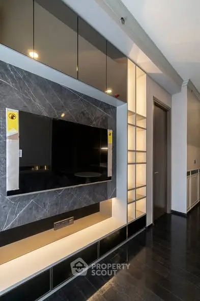 Modern living room with sleek TV wall unit and ambient lighting