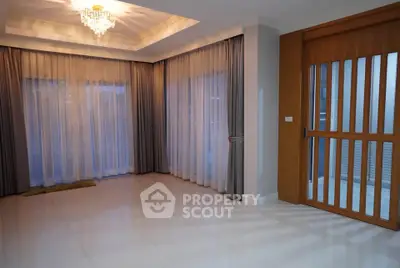 Spacious living room with elegant curtains and modern lighting
