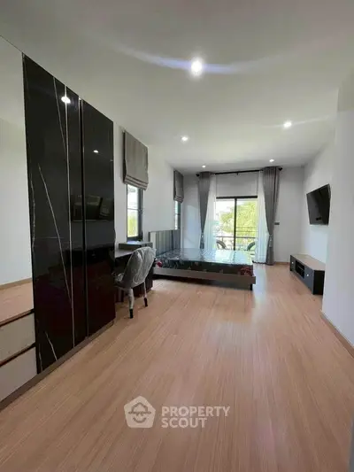 Modern bedroom with sleek design, featuring large windows and stylish furniture.