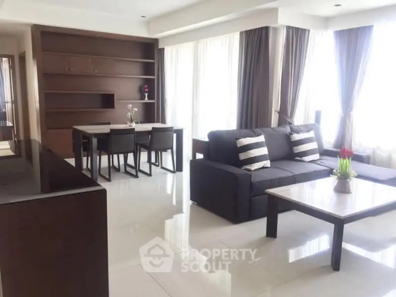 Spacious modern living room with elegant dining area and natural light