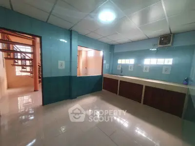 Spacious kitchen with blue tiles and ample counter space in modern home