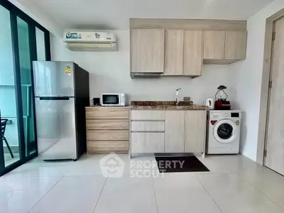 Modern kitchen with sleek appliances and stylish cabinetry in a bright, open space.