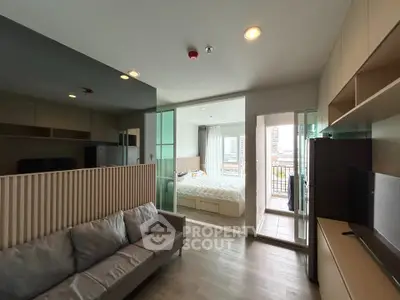 Modern apartment interior with open layout, featuring a cozy living room, bedroom, and balcony with city view.