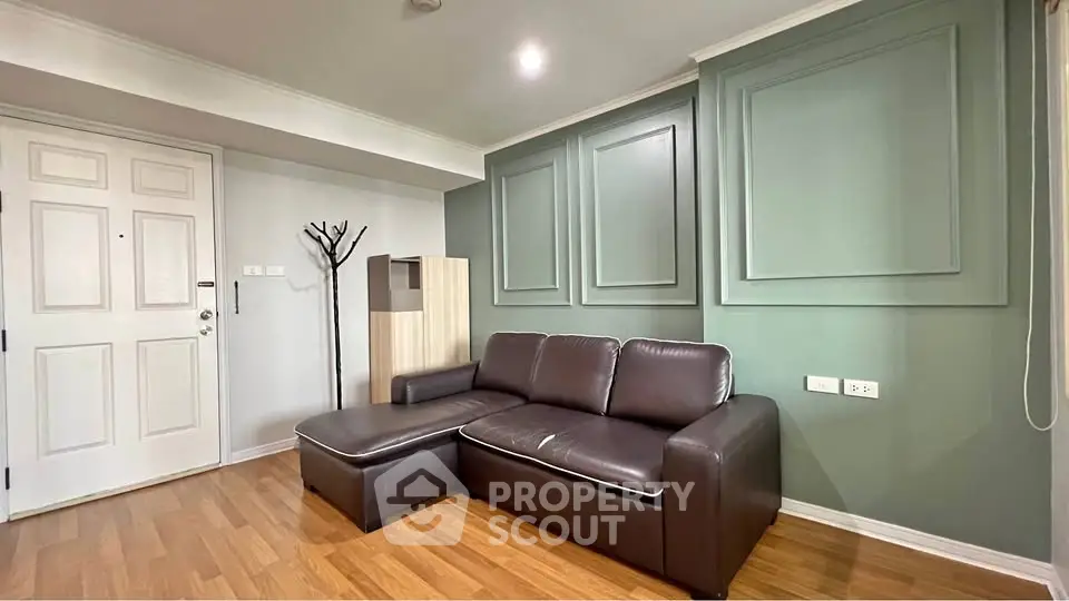 Stylish living room with modern leather sofa and elegant wall paneling