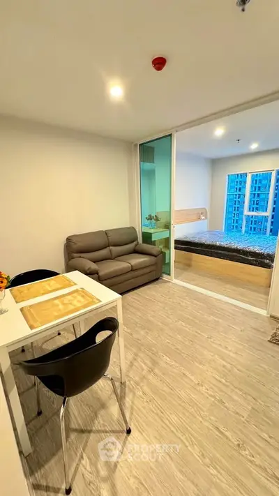 Modern apartment interior with cozy living area and bedroom view