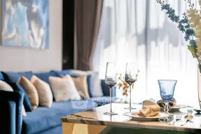 Luxurious living room with elegant decor and plush blue sofa