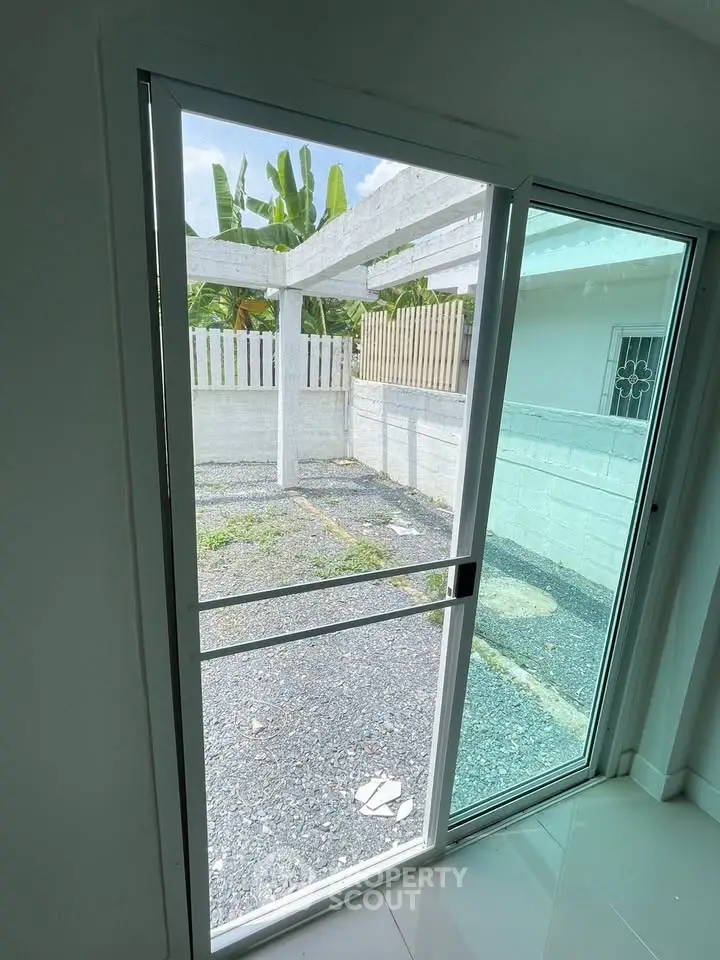 Bright patio view through sliding glass door in modern home