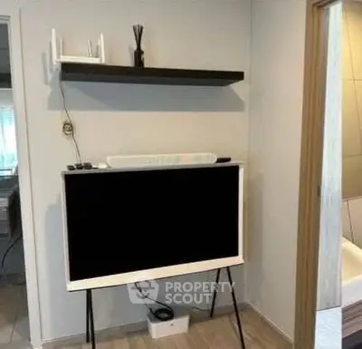 Modern interior with stylish TV stand and floating shelf in a cozy living space.