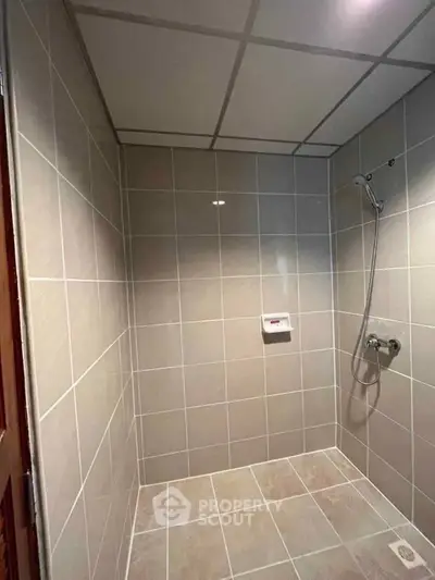 Modern tiled bathroom with shower, ideal for minimalist design lovers.