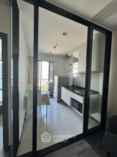 Modern kitchen with open layout and balcony view in a stylish apartment