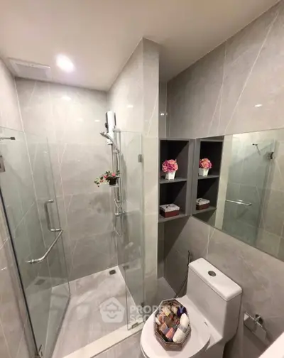 Modern bathroom with glass shower and elegant tile design