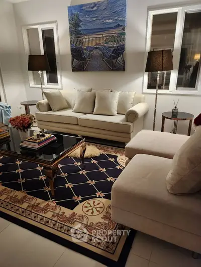 Elegant living room with plush sofas, stylish decor, and ambient lighting.