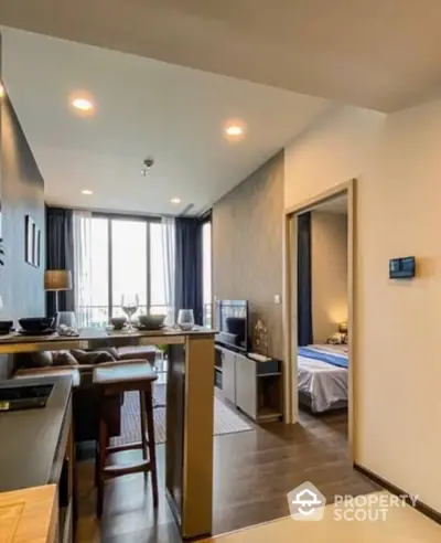 Modern studio apartment with seamless open layout, featuring a cozy living area, a sleek kitchen, and a glimpse into the tranquil bedroom, all bathed in natural light from the large window offering a city view.