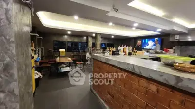 Spacious modern kitchen with open layout and stylish brick accents