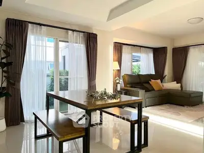 Spacious living room with modern decor and large windows for natural light