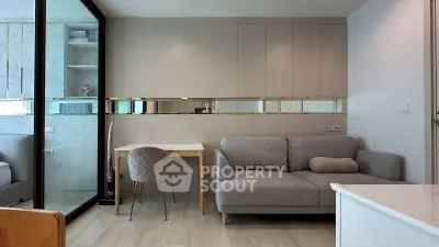 Modern living room with stylish furniture and elegant decor, featuring a cozy sofa and chic dining area.