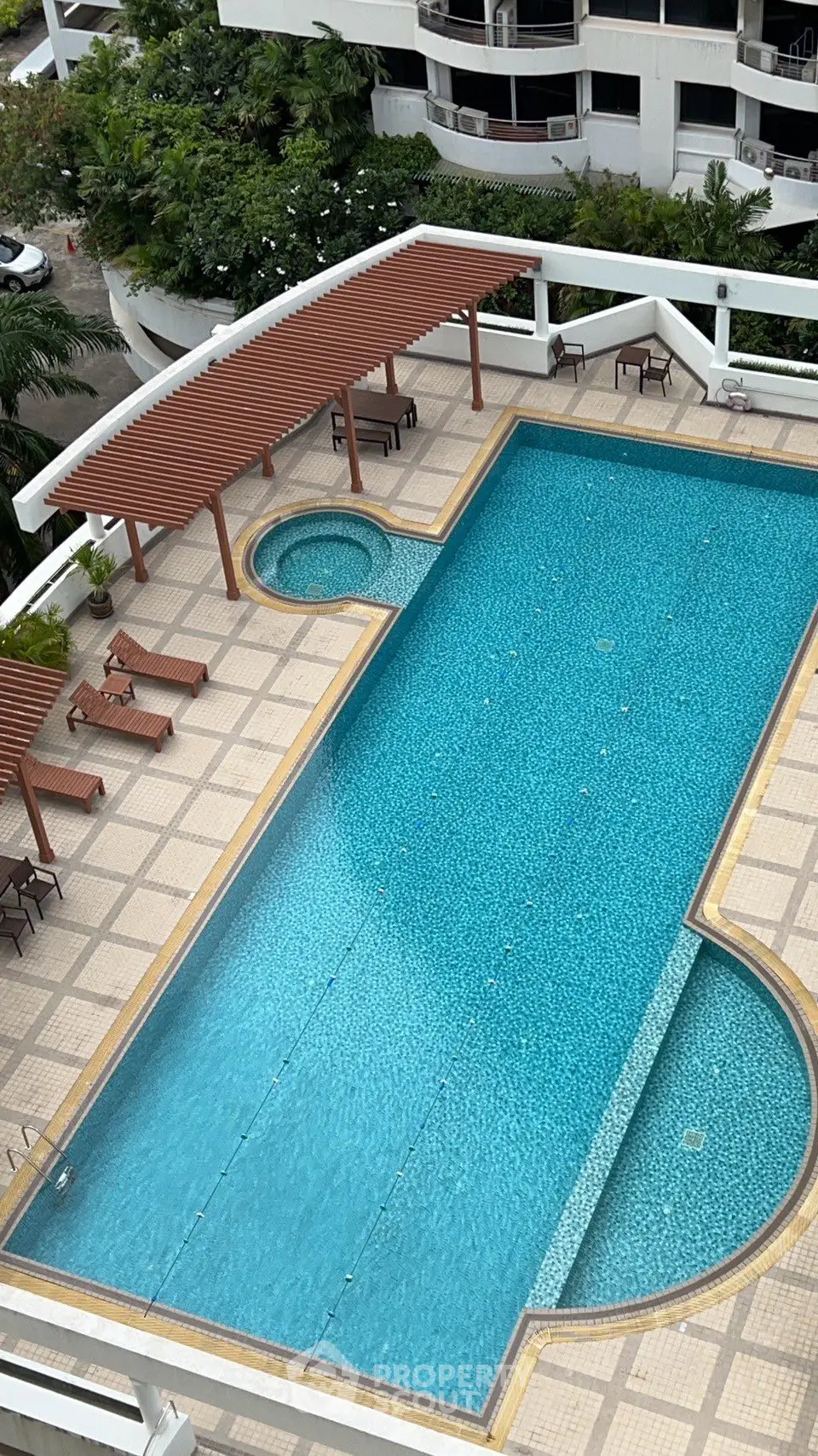 Luxurious rooftop pool with sun loungers and modern design in a high-end residential complex.