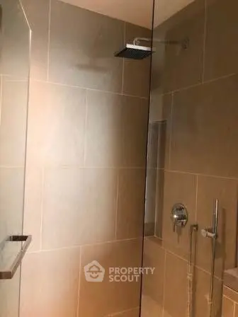 Modern bathroom with sleek shower design and neutral tiles