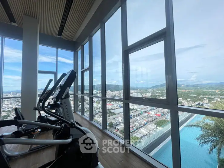 Stunning gym with panoramic city view and modern equipment