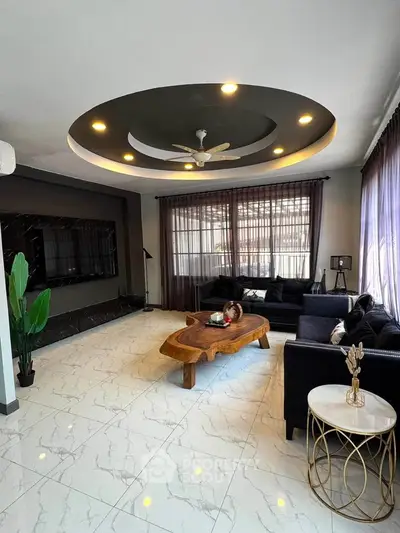 Elegant living room with modern ceiling design and cozy seating area.