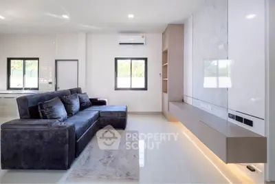 Modern living room with sleek design and luxurious sofa in bright, airy space.