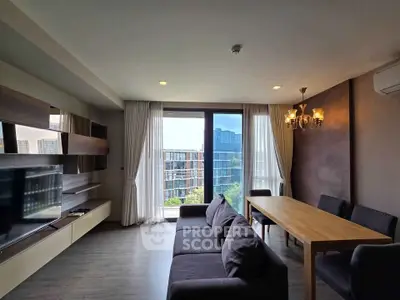 Modern living room with large windows and city view, featuring sleek furniture and elegant lighting.
