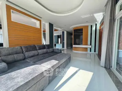 Spacious modern living room with sleek design and ample natural light.