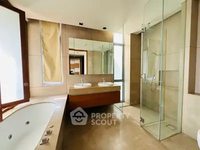 Luxurious modern bathroom with dual sinks and glass shower enclosure