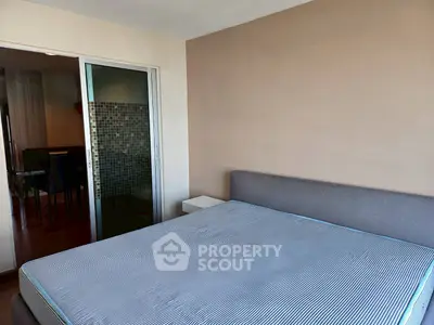 Spacious bedroom with modern decor and large bed in a stylish apartment.