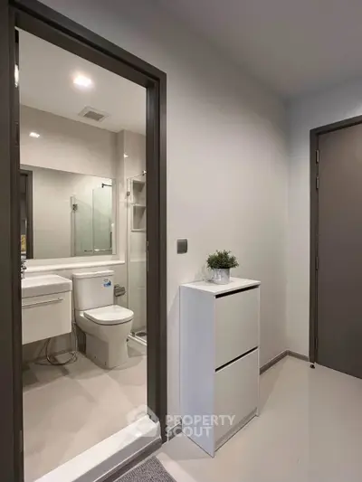 Modern bathroom with sleek fixtures and minimalist design in a contemporary apartment.