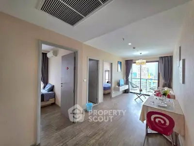 Spacious modern apartment with open layout and city view balcony, ideal for urban living.