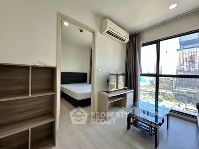 Modern apartment living room with city view, featuring sleek furniture and large windows.