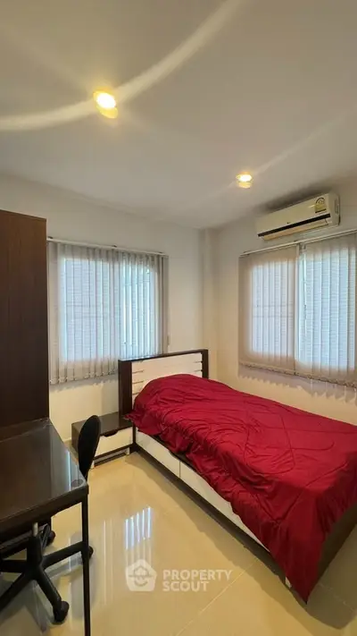 Cozy bedroom with modern furniture and natural light, perfect for relaxation and comfort.
