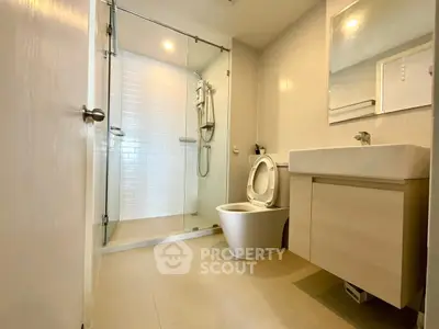 Modern bathroom with glass shower and sleek fixtures