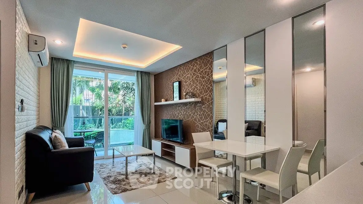 Modern living room with stylish decor and large windows overlooking greenery.