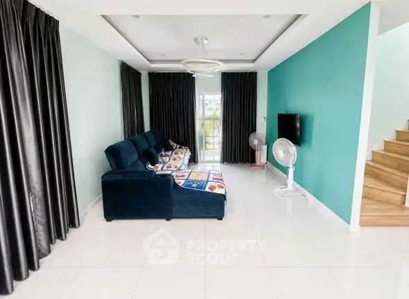 Spacious living room with modern decor and large windows for natural light.